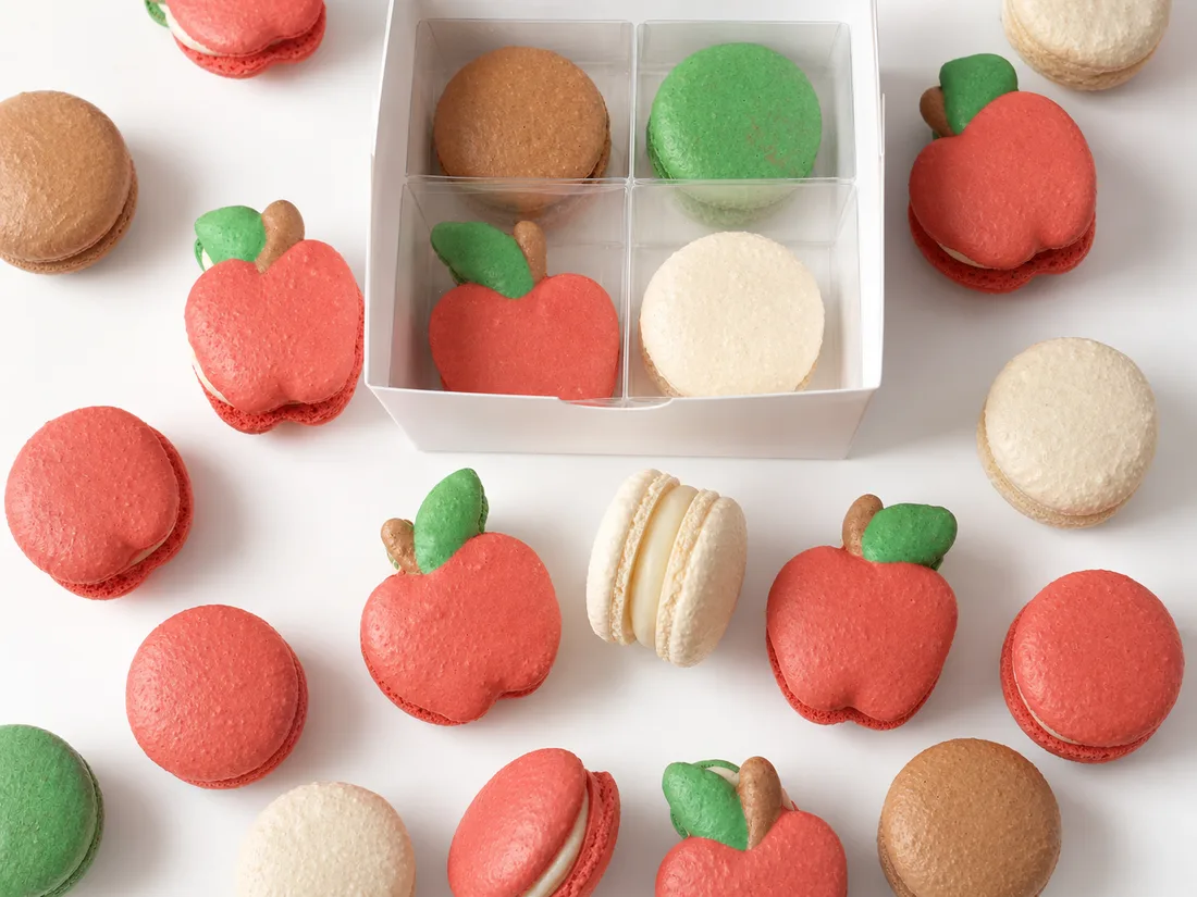 Red apple-shaped macarons and classic macarons made for a teacher celebration